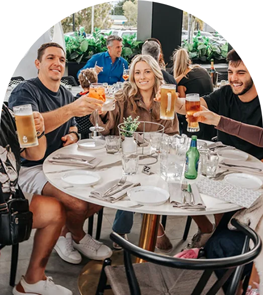 Group of friends raising drinks at a function at Enzo's Cucina
